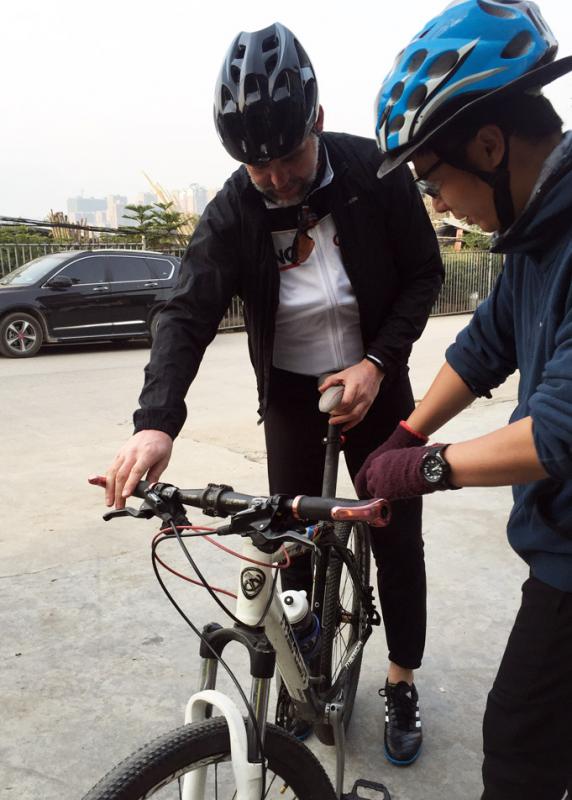 Robert Liu is preparing the bike to better fit our guests.